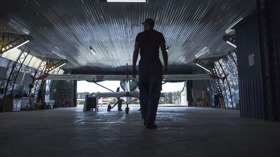 Engineer walking towards an aircraft in a hangar